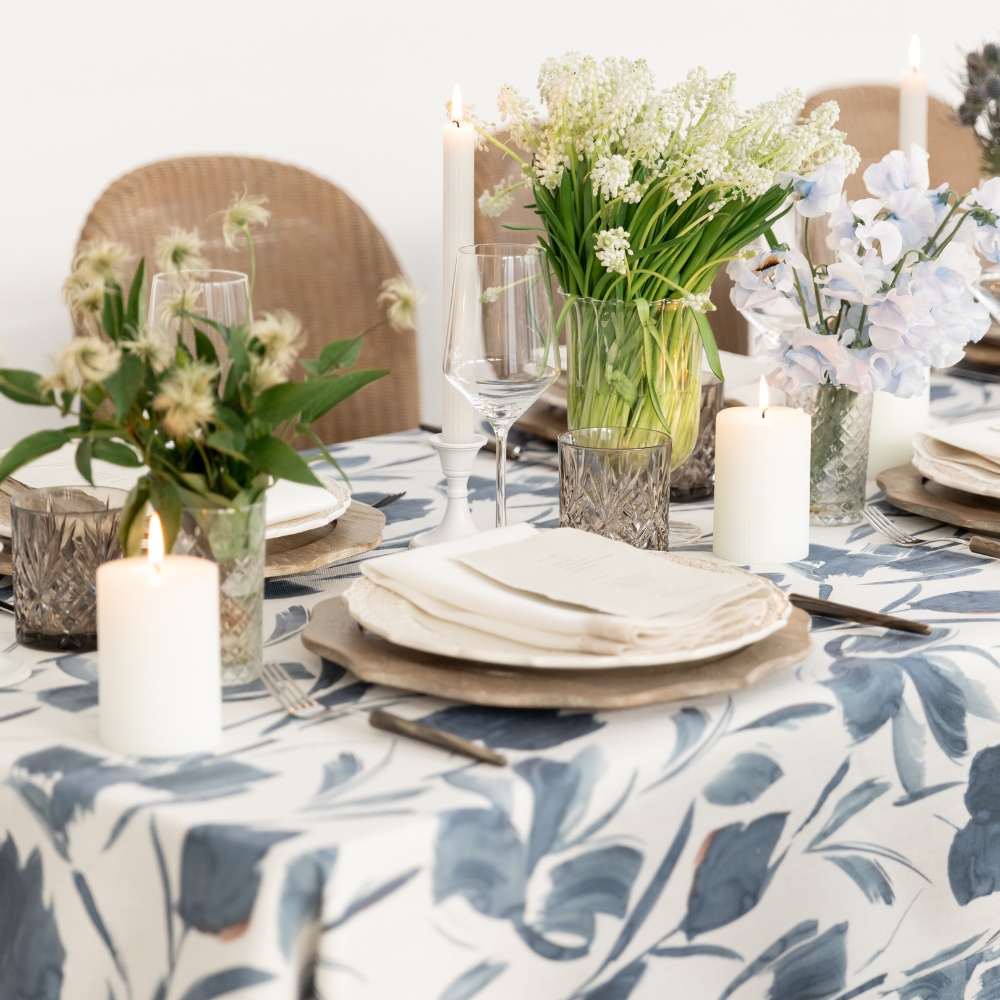 Hemstitch White & Flax Dinner Napkin and Livia Sapphire Tablecloth with rich Indigo Floral Pattern.