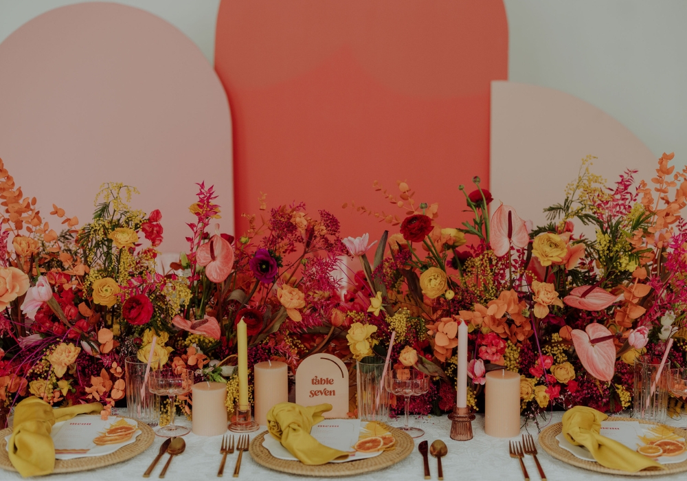 A view of a boho table setting with napkins, plates and flowers