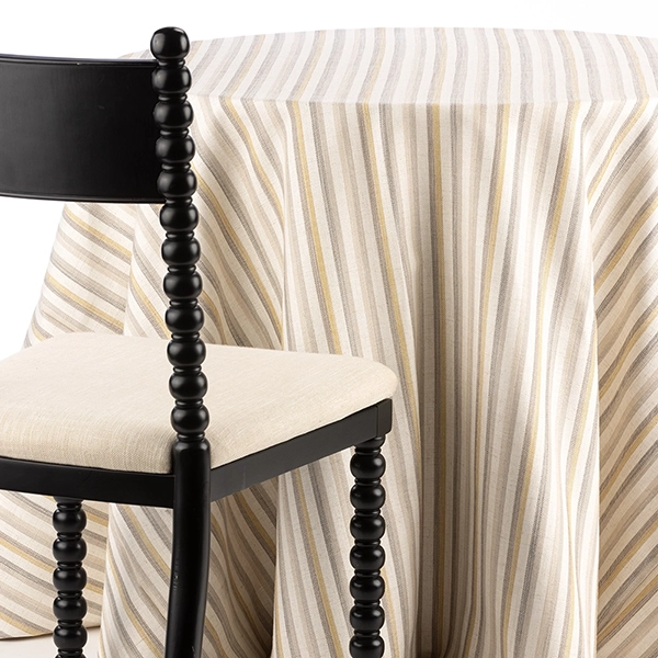 Davey Shoreline Sand Yellow Striped Tablecloth is perfect for everything from a wedding by the sea to a backyard summer dinner party.