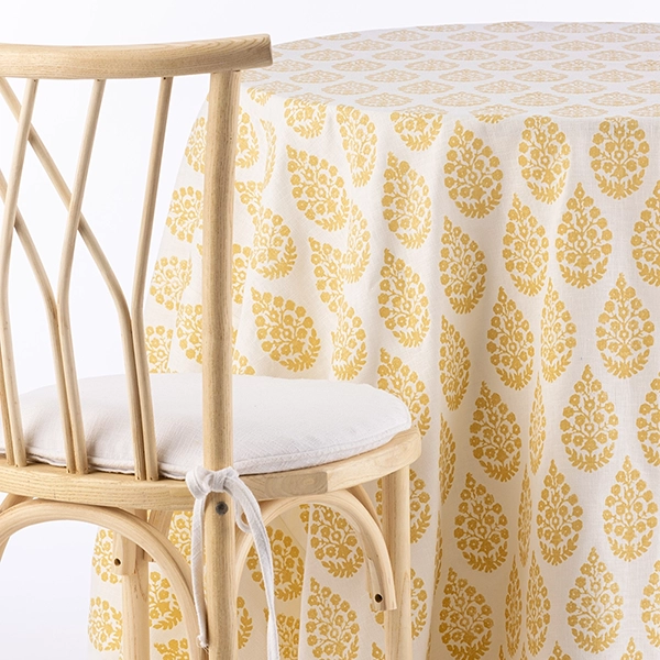 A chair next to Maisie Sunshine Vintage Tablecloth rental