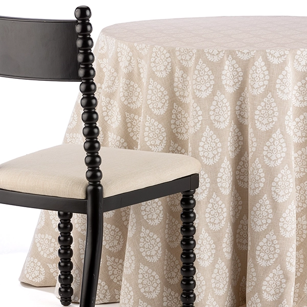 A chair next to the table with Maisie Zinc Folkloric Floral Pattern Tablecloth rental