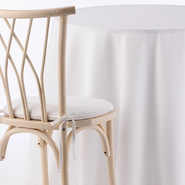 A chair next to the table with Nola White fabric