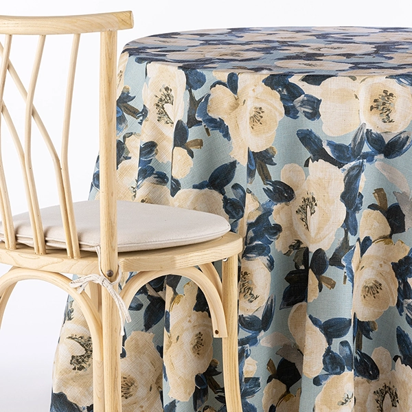 A chair next to the table with Ophelia Sky linen