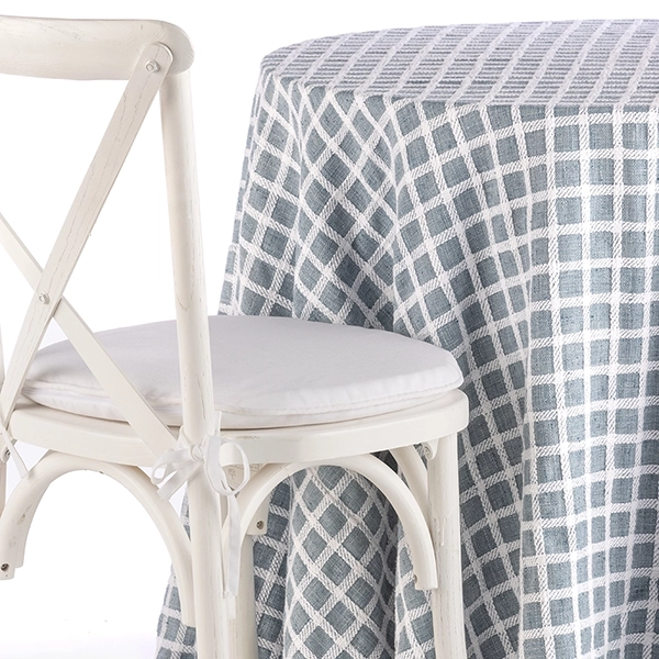 A chair next to the table with Patchwork Sea Breeze linen