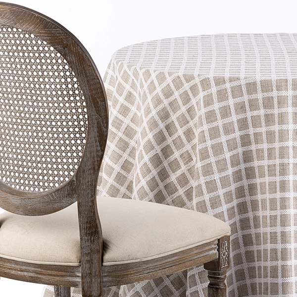 A chair next to the table with Patchwork Zinc linen