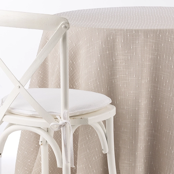 Riga Sand Linen Overlay brings a touch of effortless sophistication to the table design.