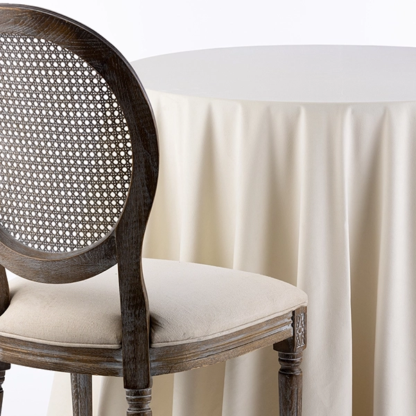 A chair next to the table with Velvet Pearl Tablecloth