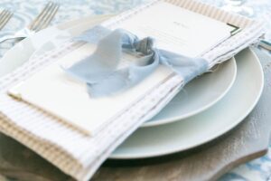 A View of a table with a coastal linen napkin with a ribbon on top