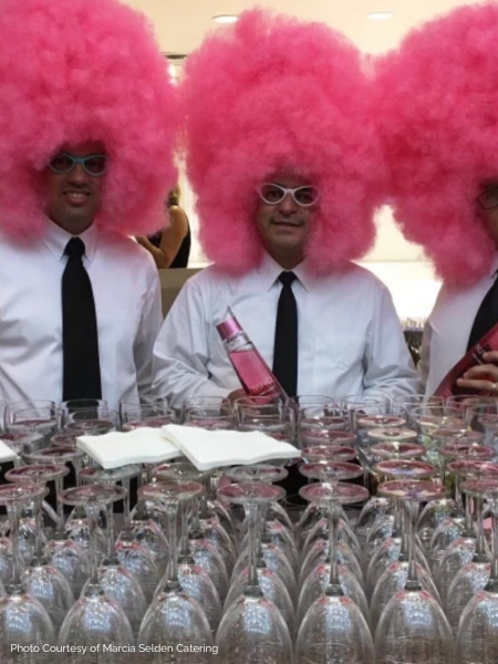 Servers with pink-colored wigs