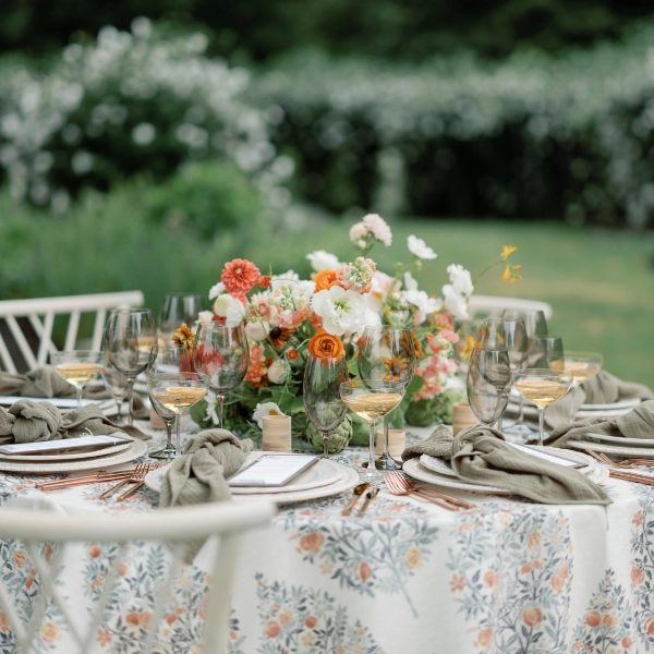 A beautifully adorned table set for a dinner party, featuring Clementine Copper event linen rental.
