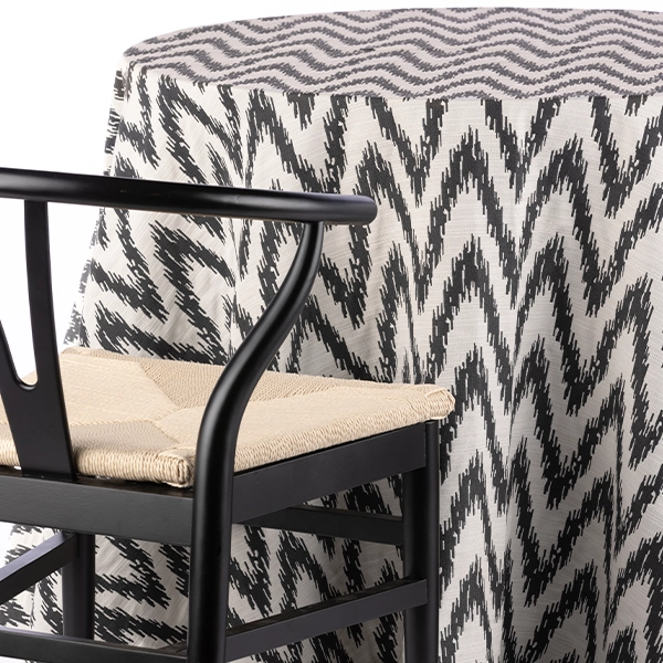 A chair with a Magma Mixed Metal patterned cloth available for table linen rental.