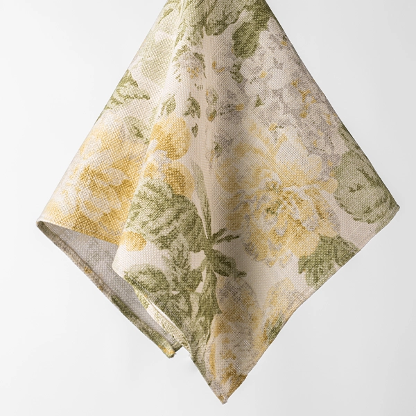 A Garden Rose Lemon Napkin patterned cloth available for event linen rental.