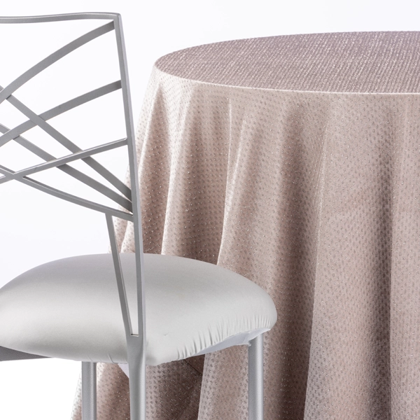 A chair next to the table with Gemma Ivory table linen