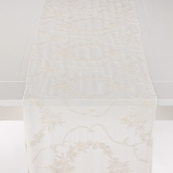 An elegant Kelly White Sheer Table Runner on a sleek white surface.