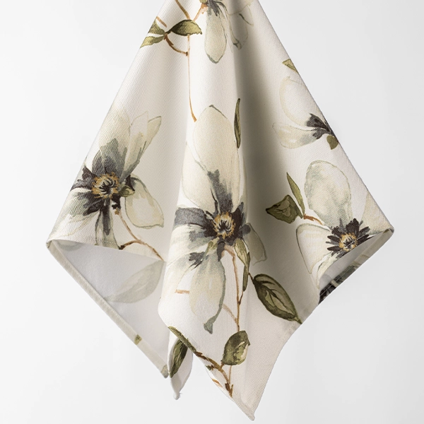 A Magnolia Fog Napkin with a floral pattern available for event linen rental.
