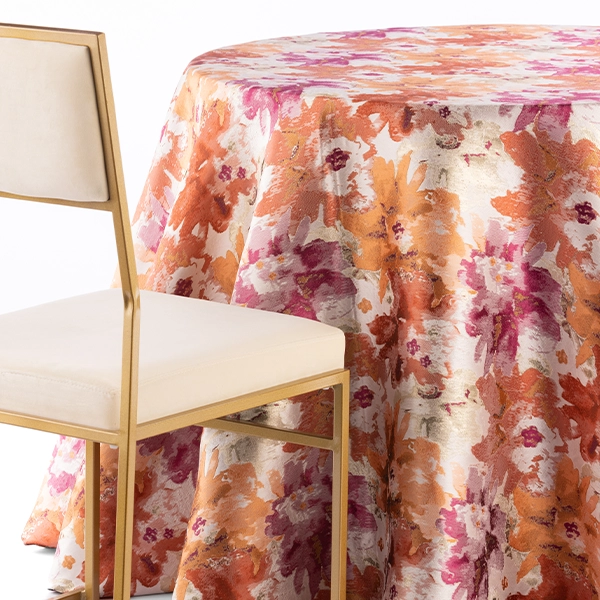 A Penelope Pomegranate chair and table linen rental for events.