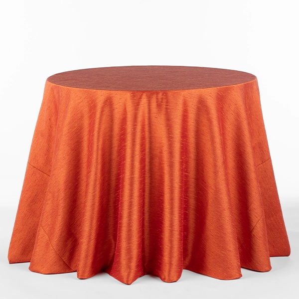 A view on the Tussah Sunset Orange Red tablecloth rental in full size