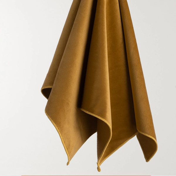 A Velvet Rust cloth from a wooden shelf available for table linen rental.