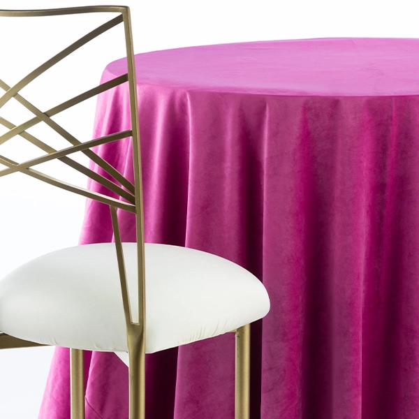 An Velvet Magenta chair next to a table
