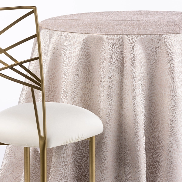 A chair next to the table with Metallic Vines Rose Gold table linen