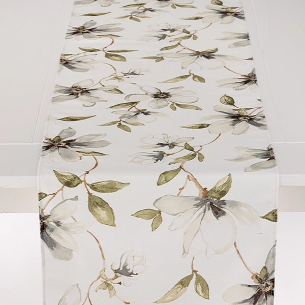 A Magnolia Fog table runner with flowers on it available for event linen rental.