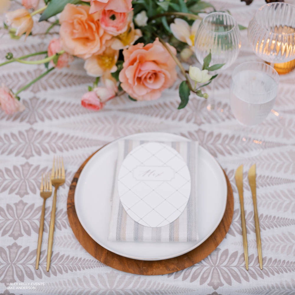 Elegant table setting with Jolie Wheat floral centerpiece and gold cutlery.