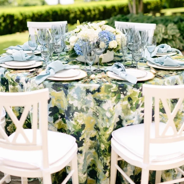 A beautifully adorned table set for a dinner party, with exquisite Bouquet Garden linens available for event linen rental.