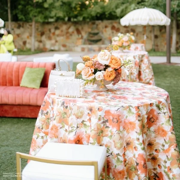 An event table with Layla Floral flowers on it, available for table linen rental.