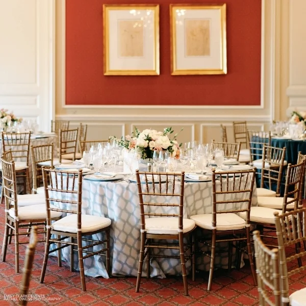A room with Lexington Seafoam tables and chairs set up for a wedding reception. Optional table linen rental available.