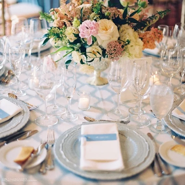 An elegant Lexington Seafoam table setting featuring beautiful blue and white flowers, perfect for any event or occasion.