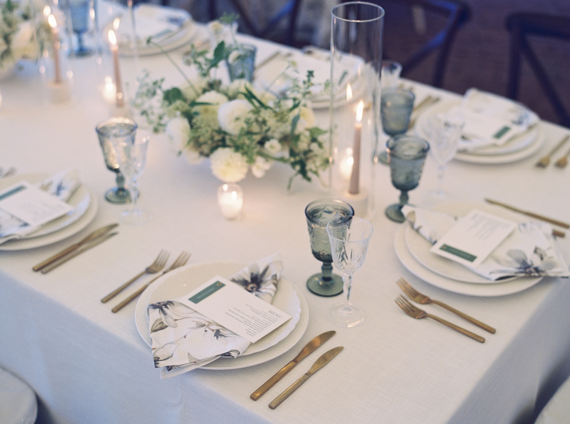 A table set for an elegant dinner party, featuring exquisite event linens.