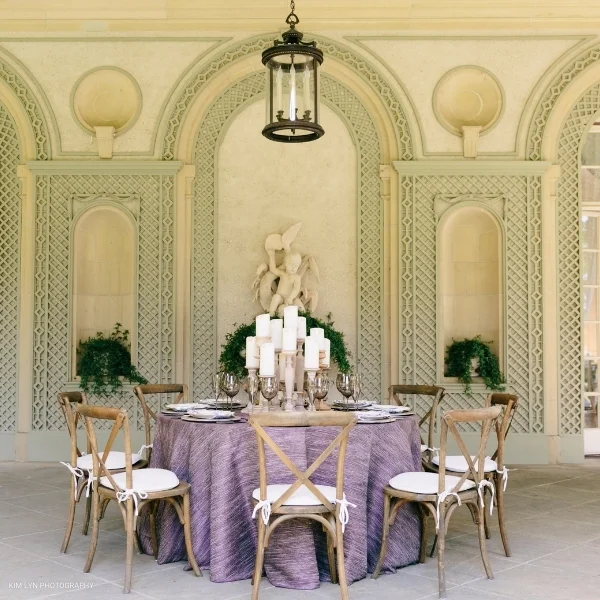 A Millennial Purple table linen rental in an ornate room.