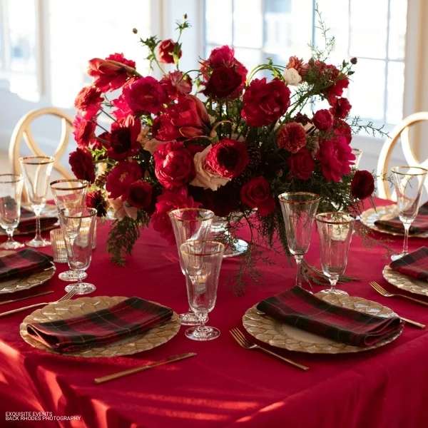 An elegant table setting adorned with red roses and silverware, perfect for a special event or occasion,  enhanced by the Montana Suede Lipstick.