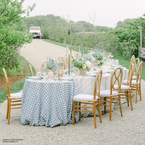 A Patchwork Sea Breeze table set up for an event or dinner party with beautiful table linen rentals.