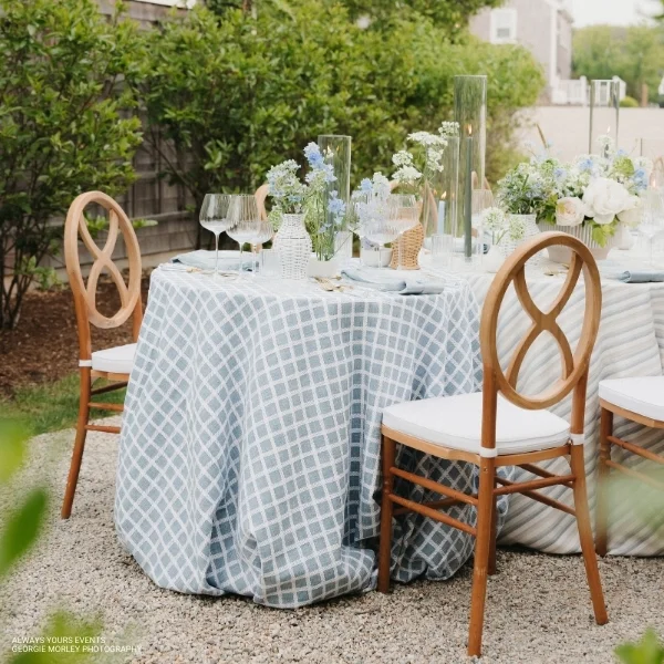 A table set up for a party with Patchwork Sea Breeze event linen rental.
