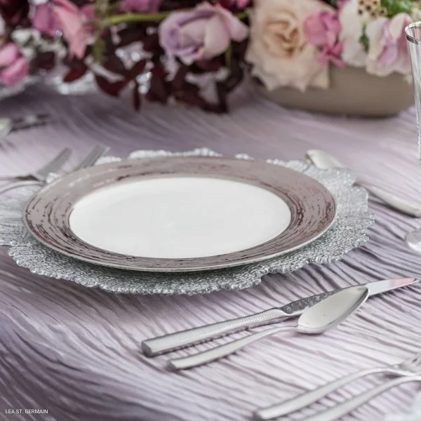 A table setting with silverware and River Lavender rental on a purple tablecloth.