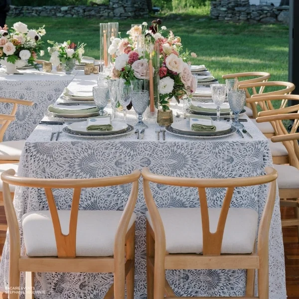 A table set for a wedding with elegant Sophia Lace tablecloth - perfect for your event linen rental.