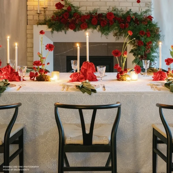 An elegant table adorned with candles and flowers for your upcoming event. We offer exquisite Sophia Lace event linen rental options, including Sophia Lace table linen rental services to enhance the ambiance of your occasion.