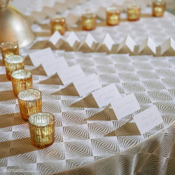 A table with Stella Champagne and candles available for event linen rental.