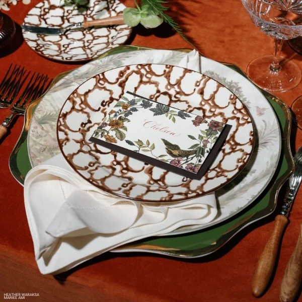 A table setting with plates, silverware, and Velvet Rust rental.